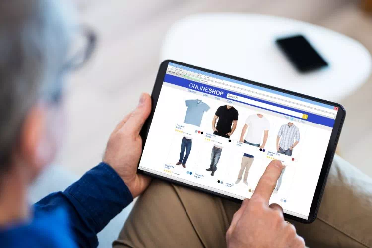 Homme en train d'acheter des vêtements sur sa tablette