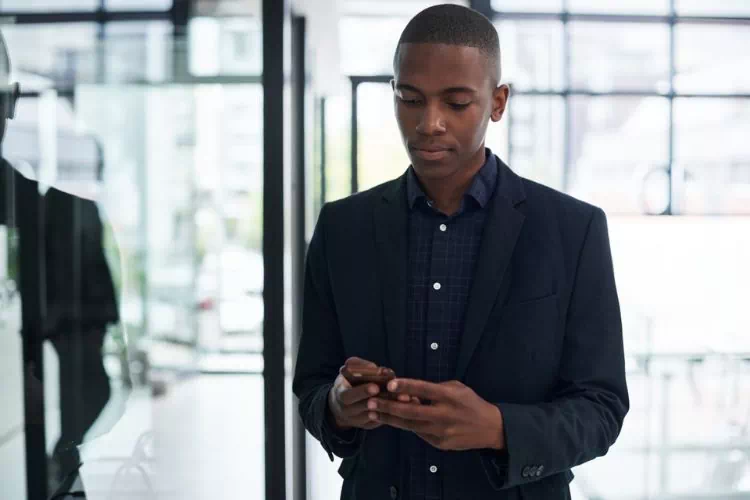Jeune homme avec son téléphone au travail