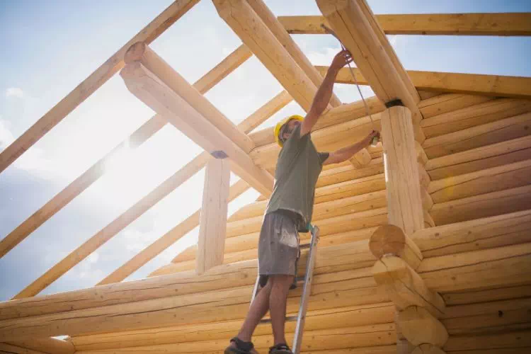 Fustier en pleine construction d'une maison en bois
